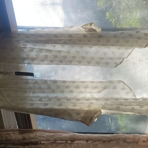 Cream with heart embroidery in the same monochromatic color.  Melissa McCarthy 7